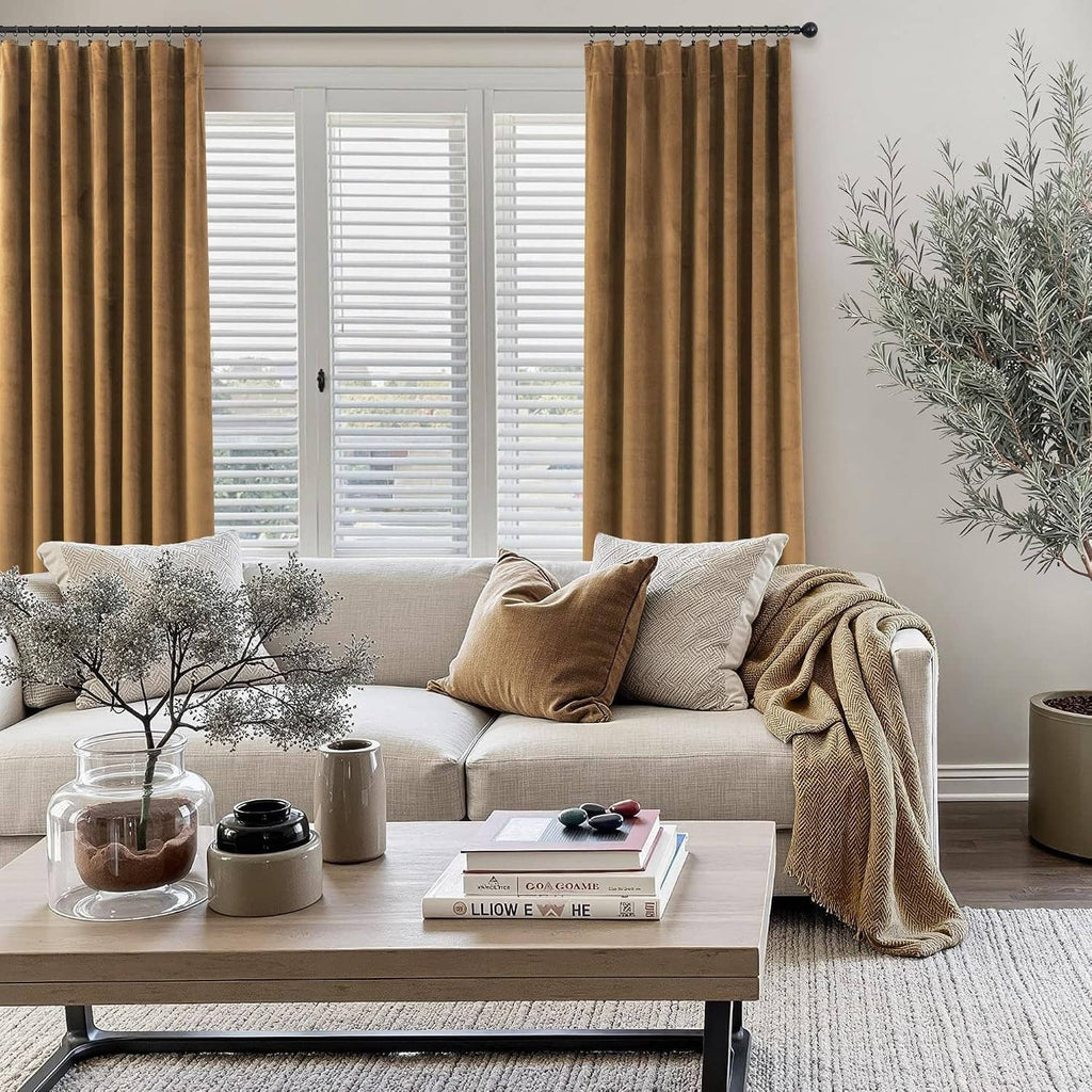Gold brown velvet curtains, two panels hung on a black curtain rod.