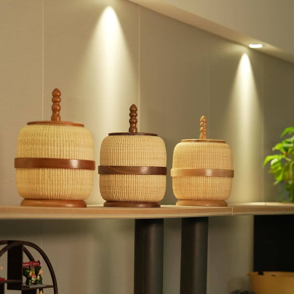 Set of woven rattan storage baskets with wooden lids and finials, yellow beige