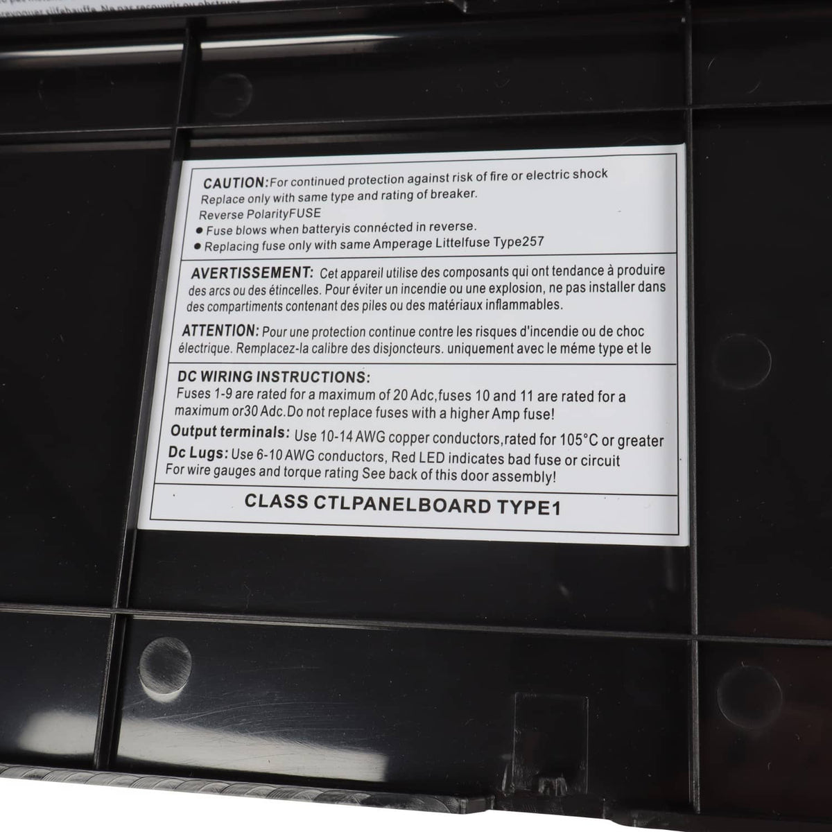 RV power converter with caution label and safety instruction panel inside housing