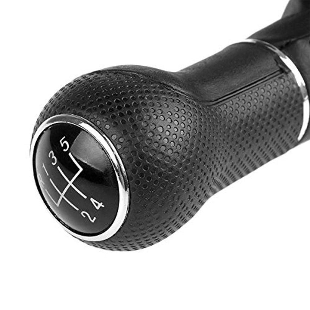 Close-up of 5-speed gear knob showing shift numbers on black dial with textured leather