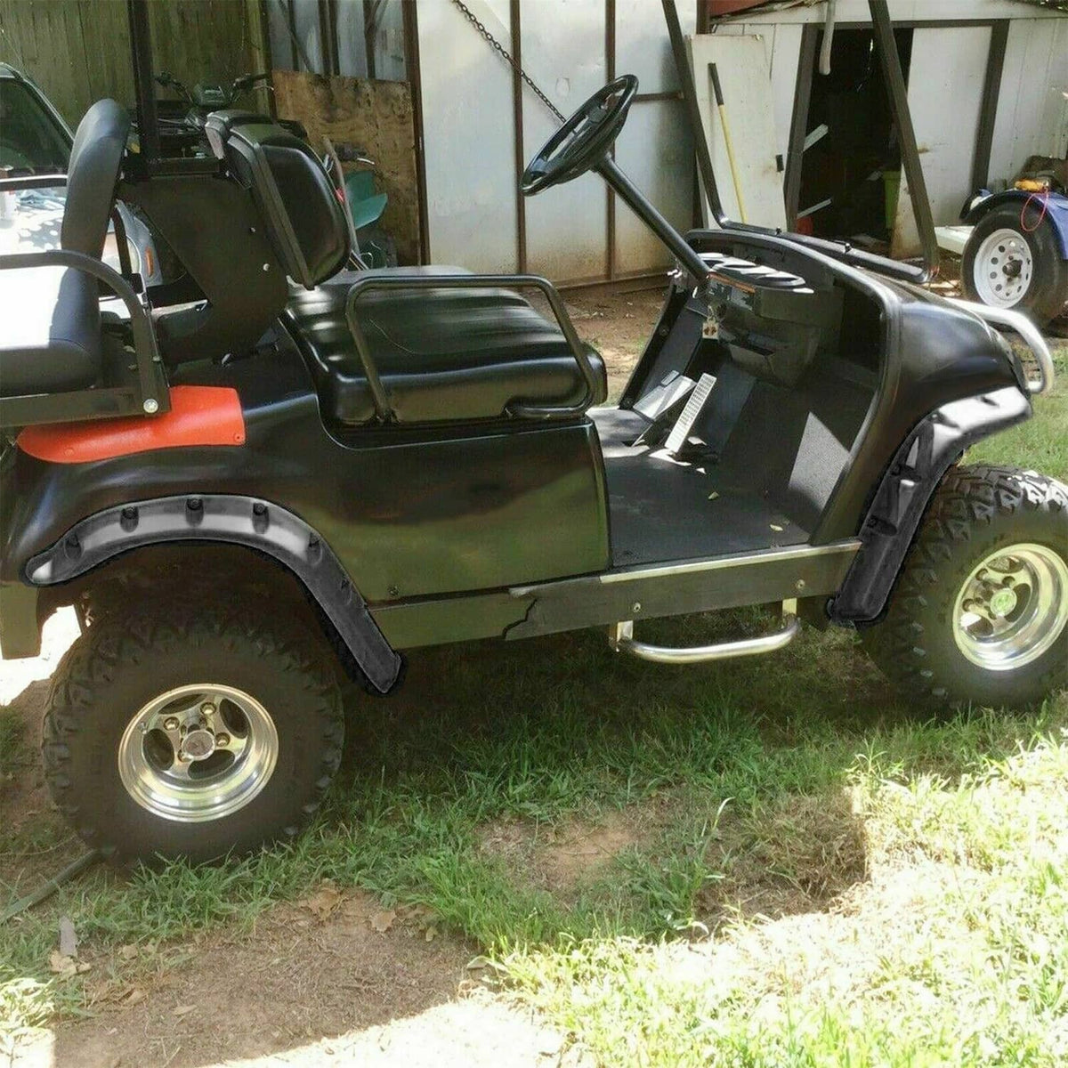Golf cart with dark gray/black fender flares covering front wheel arch areas