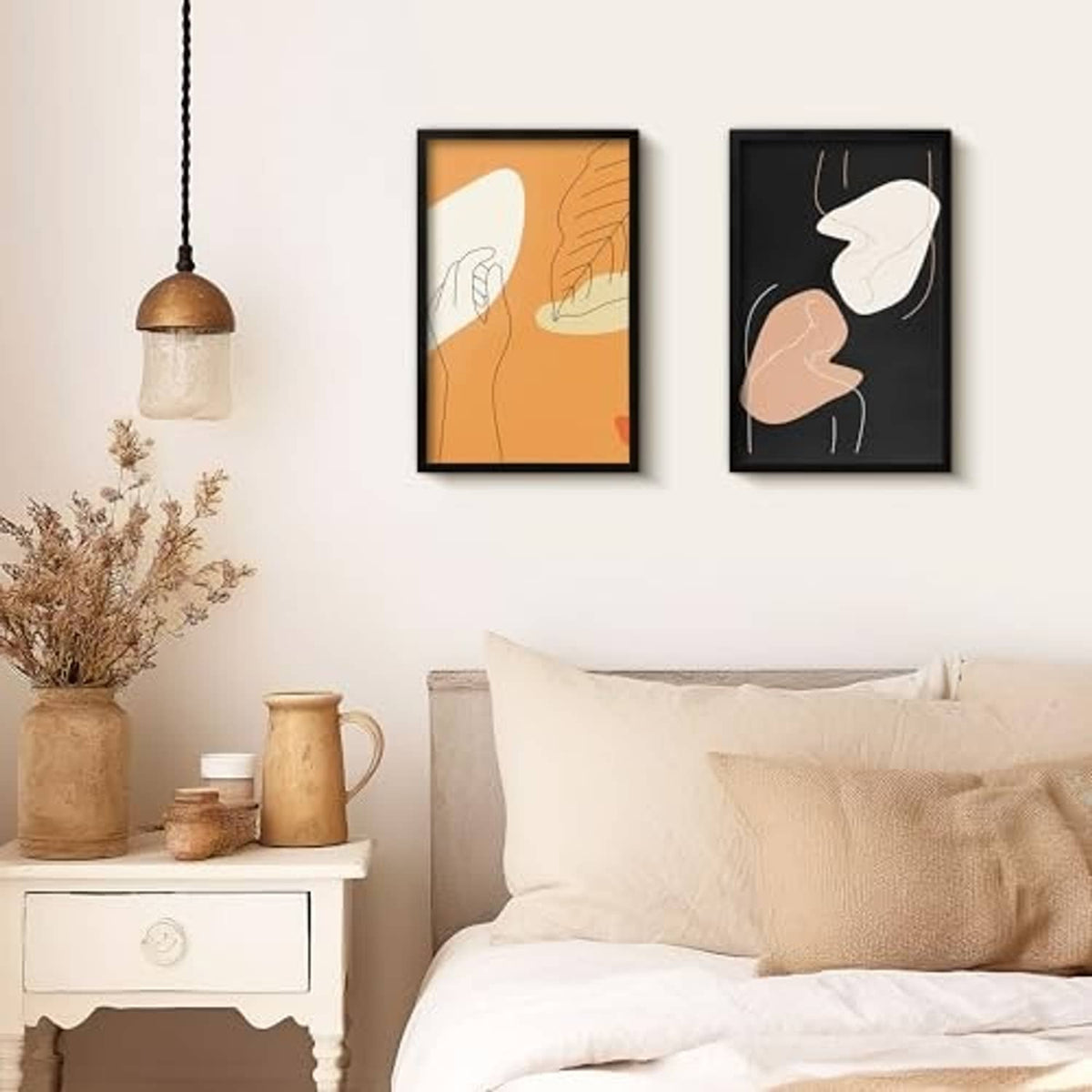 Black 11x17 poster frames on wall above sofa in a living room