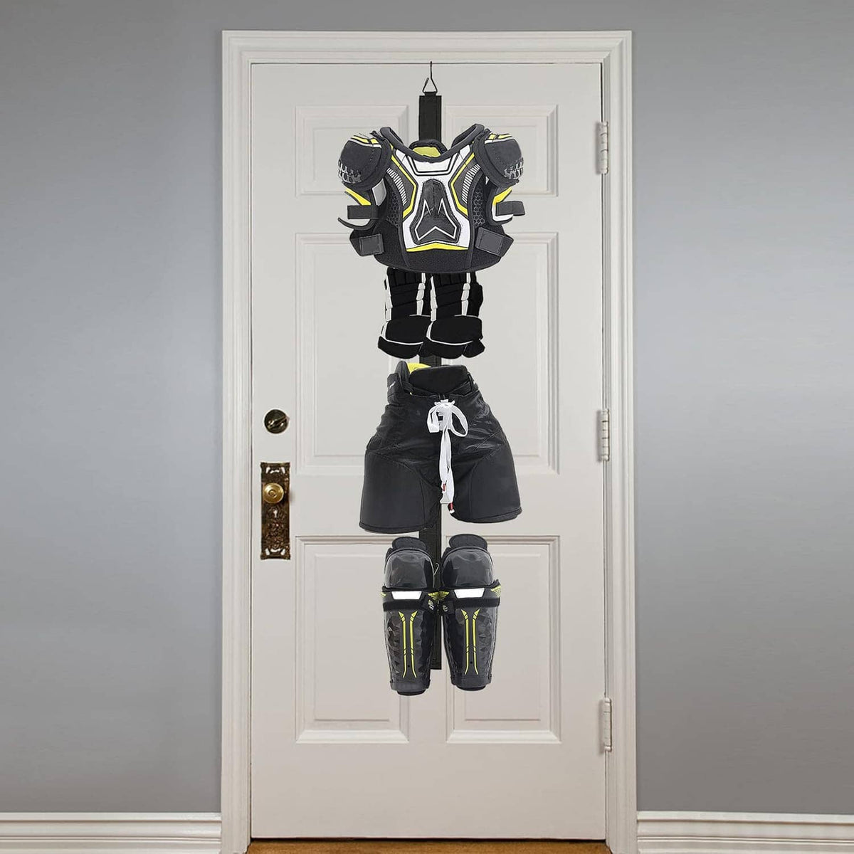 Over-door hockey drying rack hanging hockey shoulder pads, shorts, and shin guards