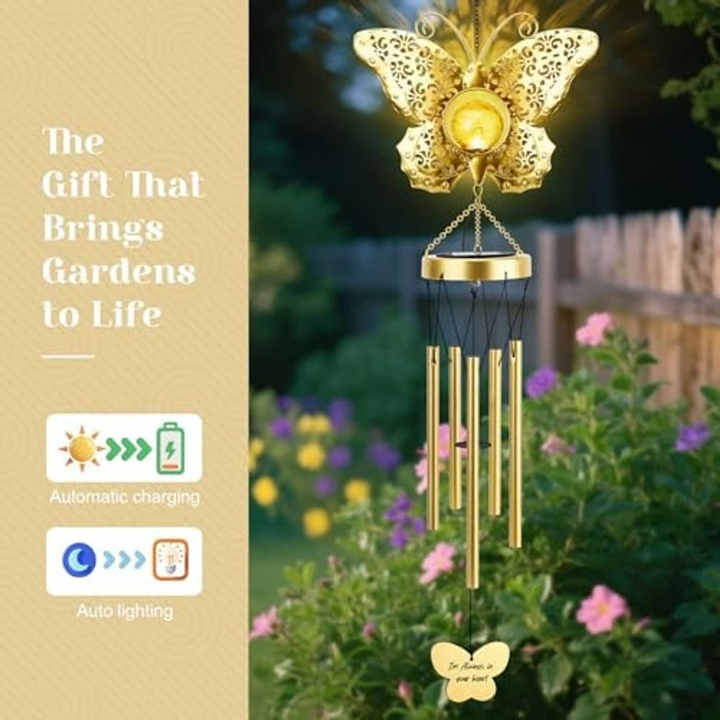 Golden butterfly solar wind chime with filigree wings, round glowing bulb, and tube strands