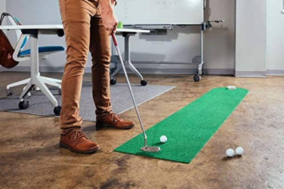 Green putting mat with golf ball and tee markers