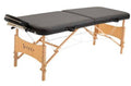 Portable massage table with black padded top, face cradle, and wooden legs