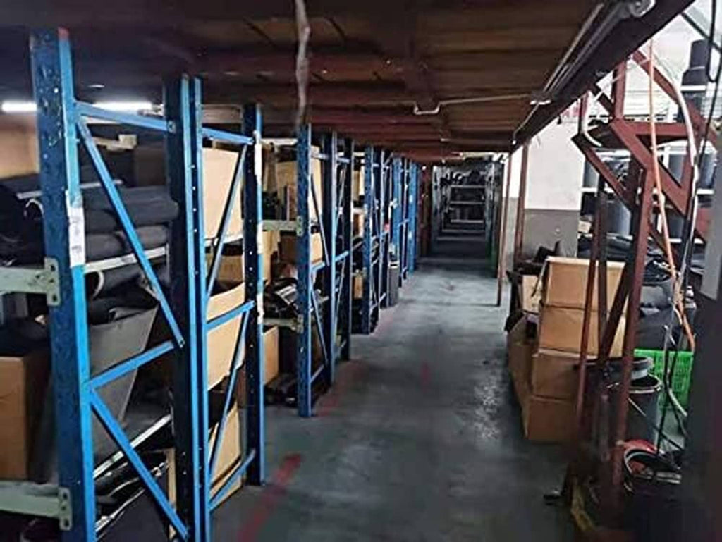 Warehouse aisle with metal shelving and stacked supplies