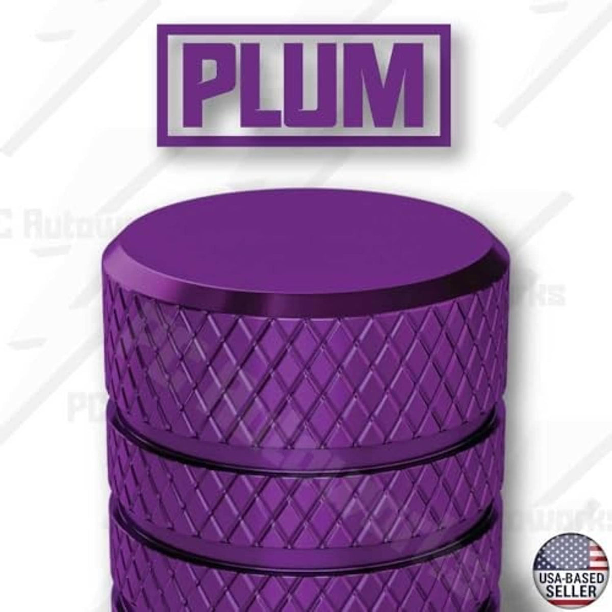 Plum purple tire valve stem cap close-up, textured sides with a smooth flat top