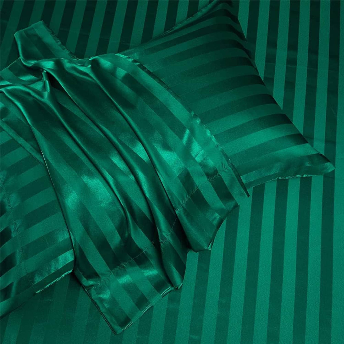 Teal green satin bedding close-up with horizontal stripes and gathered folds