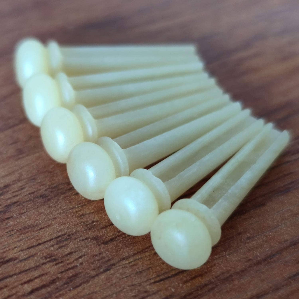 Set of white bone acoustic guitar bridge pins with round heads