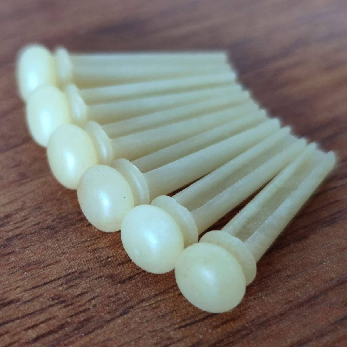 Set of white bone acoustic guitar bridge pins with round heads