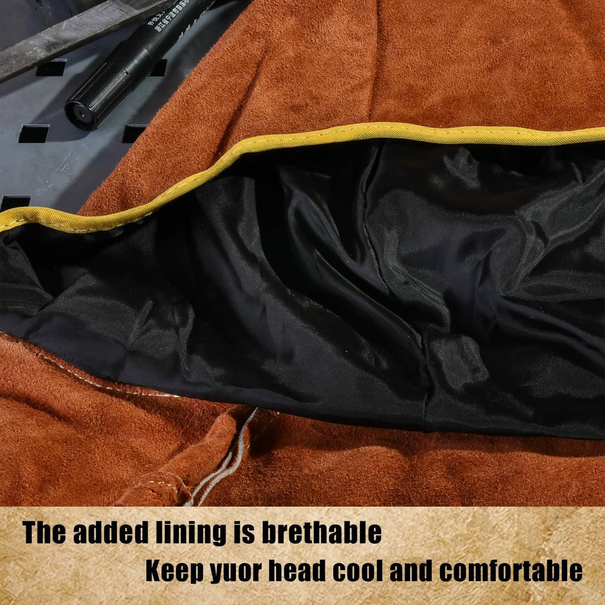 Orange welding hood with black inner lining and yellow-trimmed collar