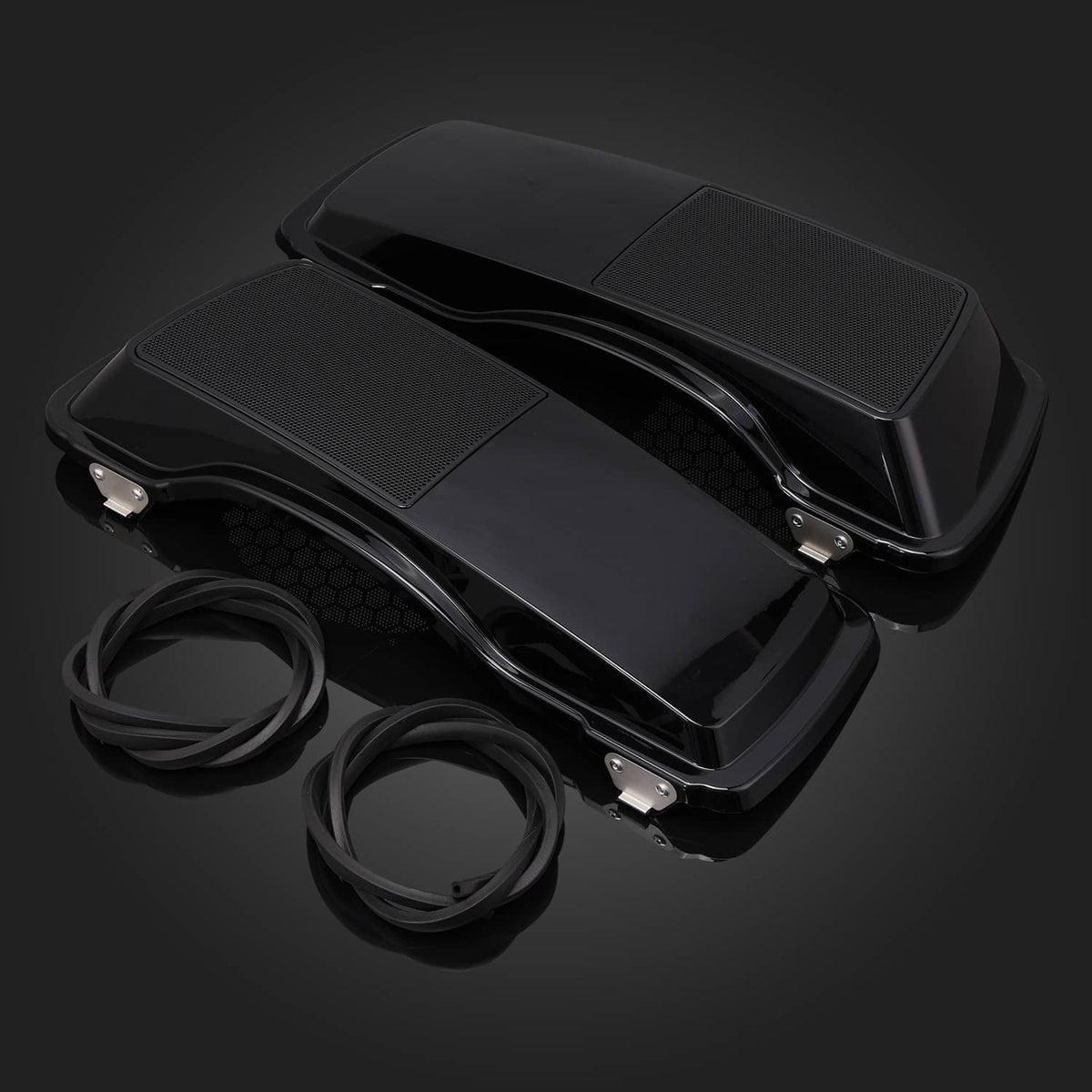 Black hard saddlebag speaker covers with textured grilles, mounted hardware, and cables