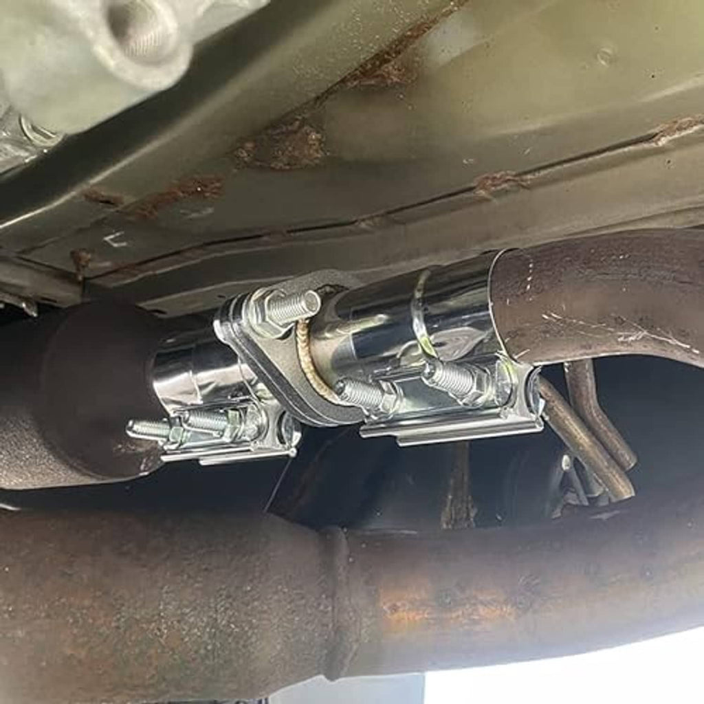 Installed exhaust flange repair clamp and gasket holding a muffler-to-pipe joint.