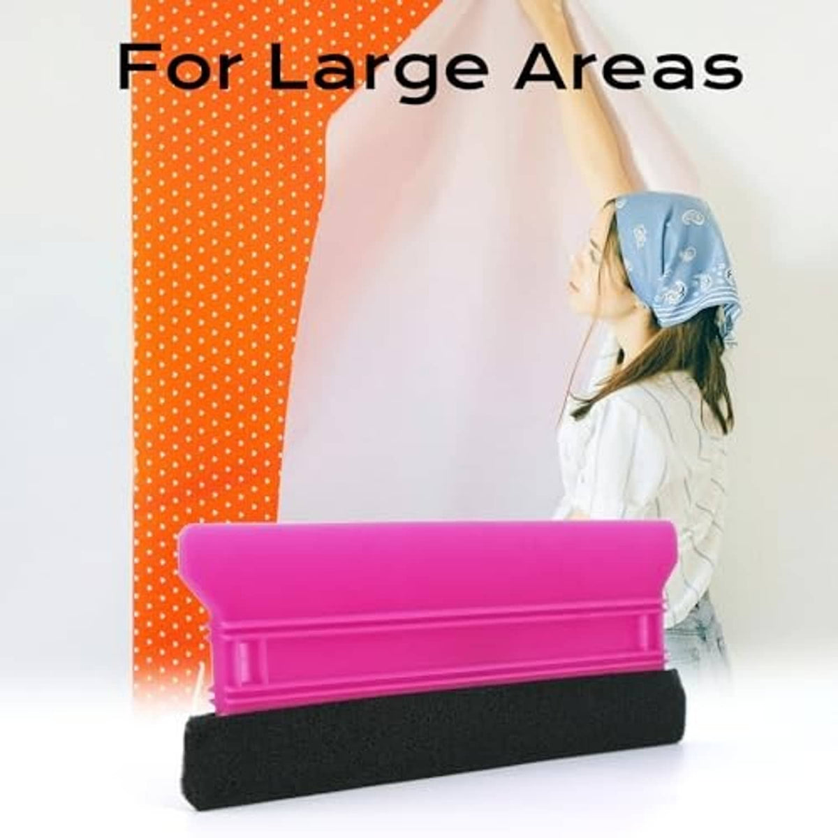 Pink felt-edge squeegee for vinyl film, pressing a large sheet
