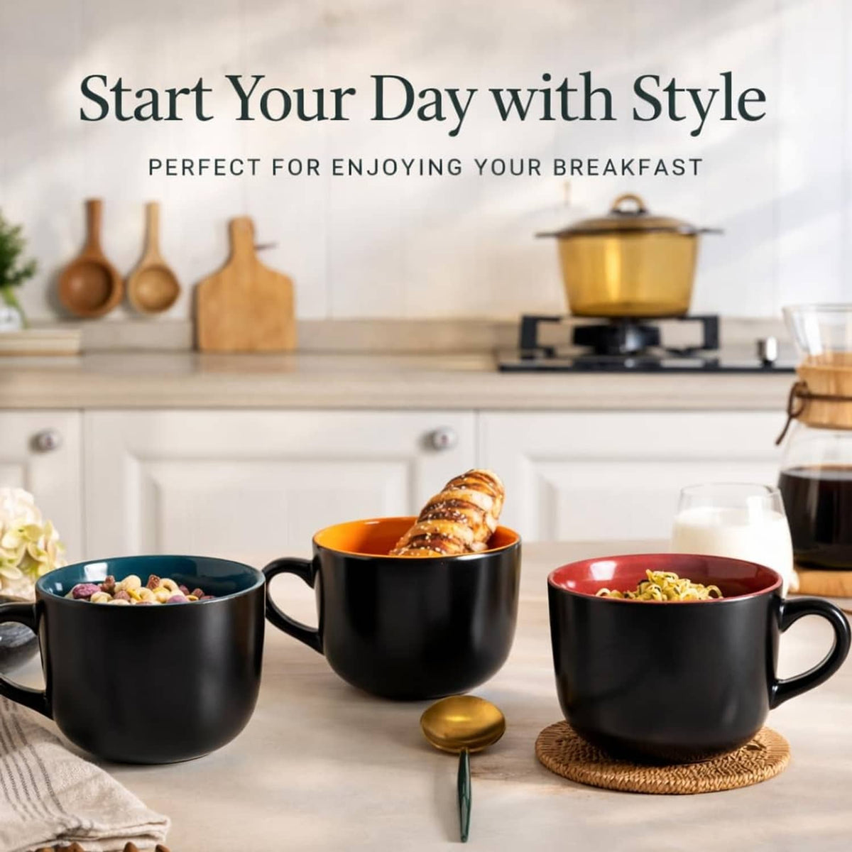 Four soup mugs with handles on table, black exterior with orange and red interiors