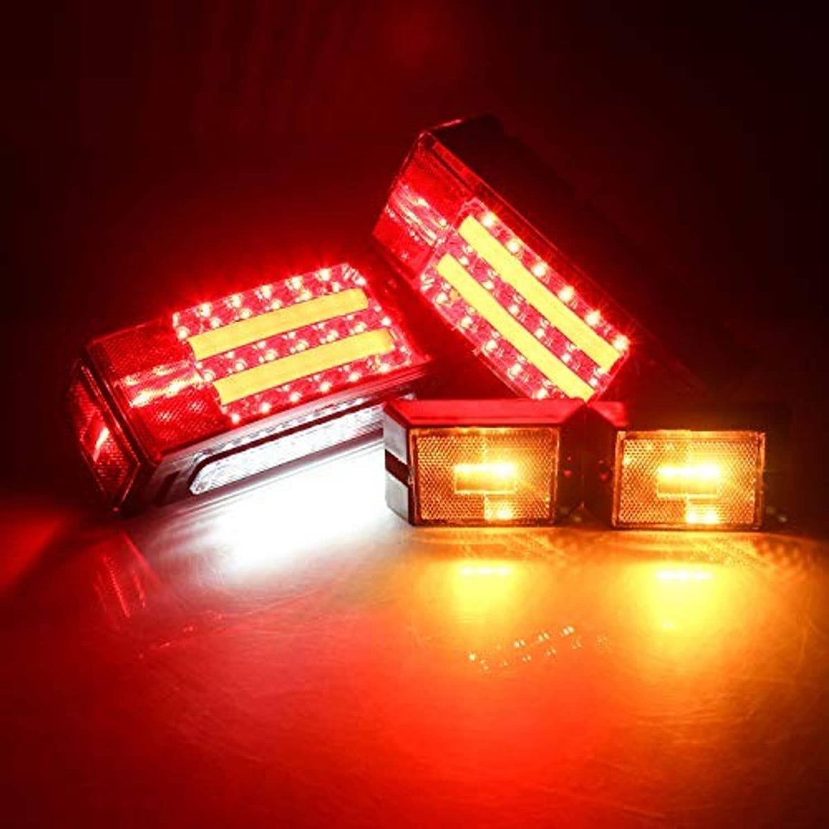 LED trailer lights glowing red and amber with clear lenses and stacked LED bars