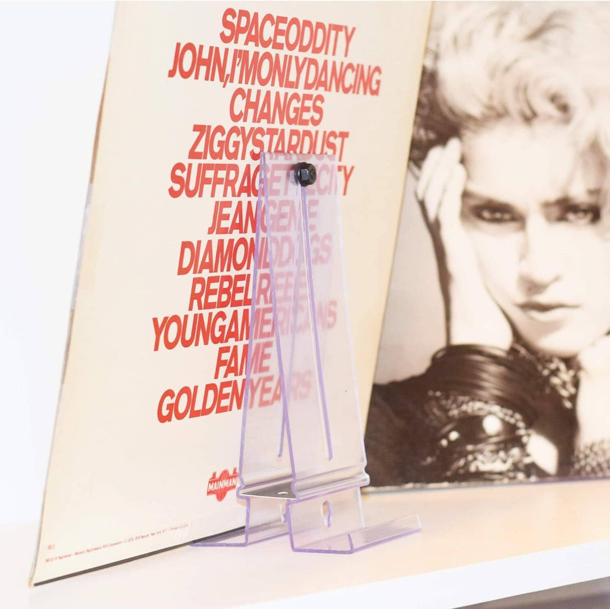 Clear standing wall-mount album display bracket holding a record cover