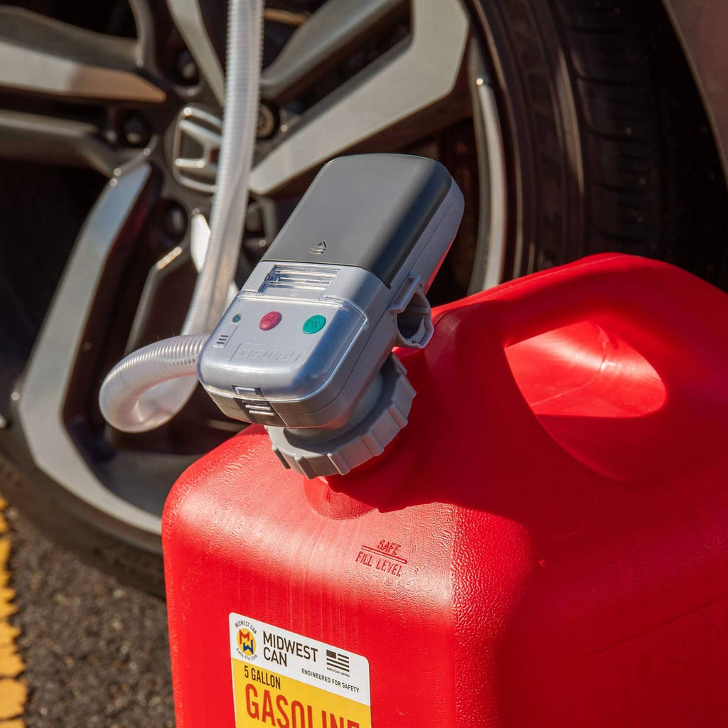 Fuel transfer pump dispensing nozzle attached to red gas can