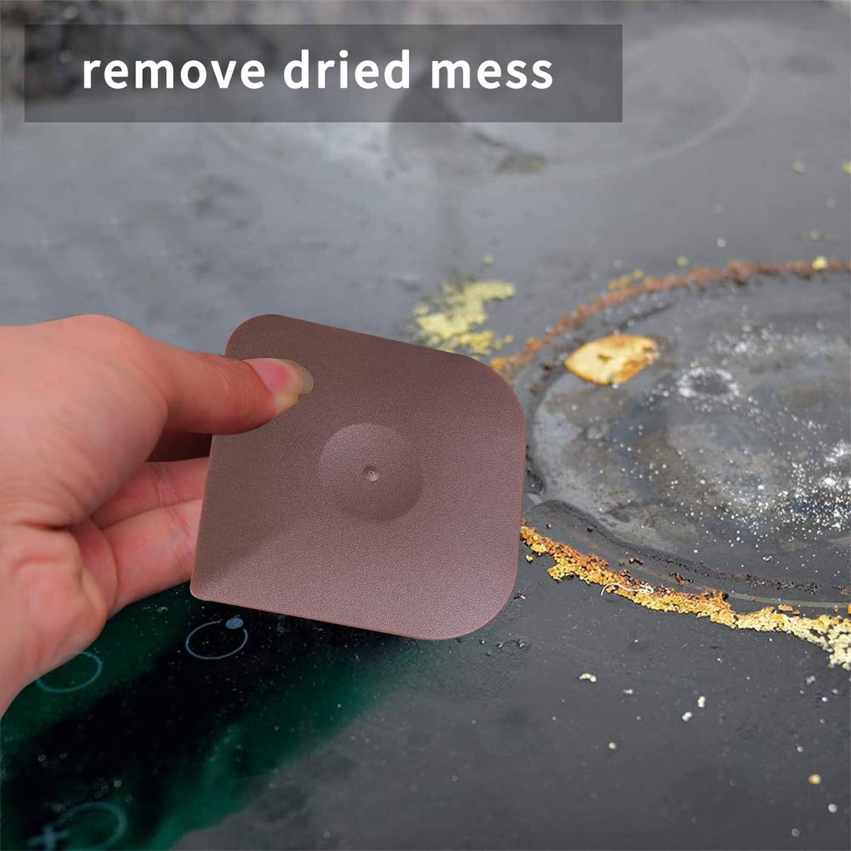 Brown pan scraper pad in use, lifting dried residue from a skillet