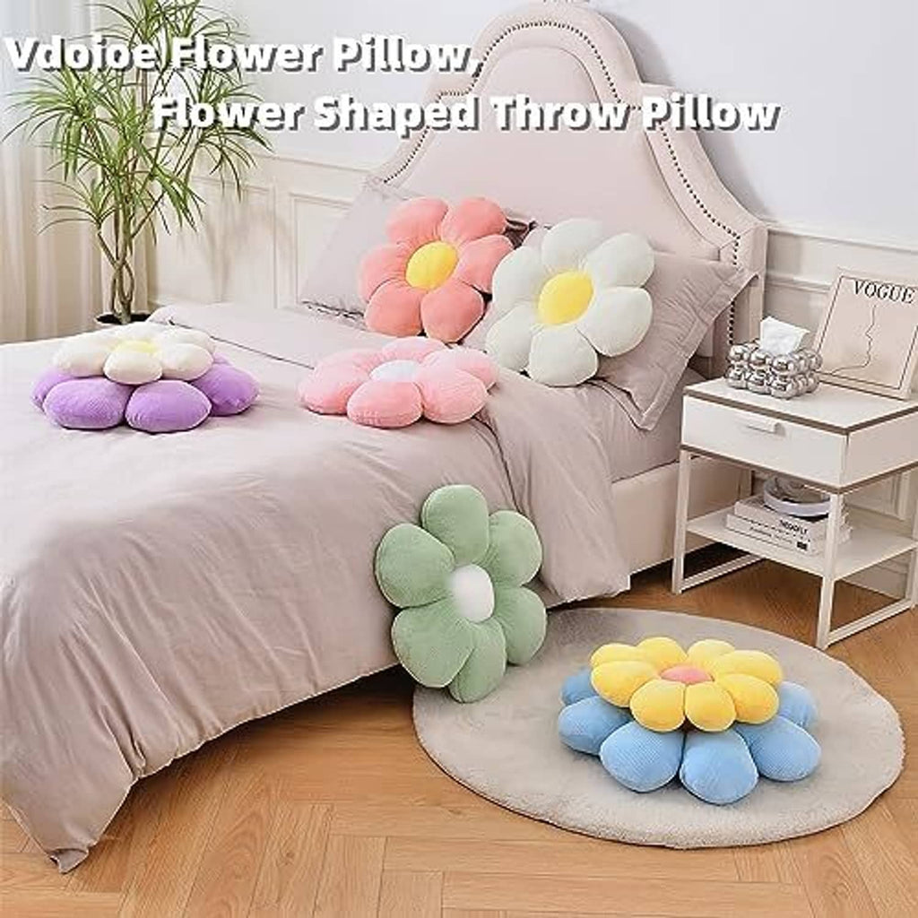 Pastel flower shaped throw pillows on a bed and round rug