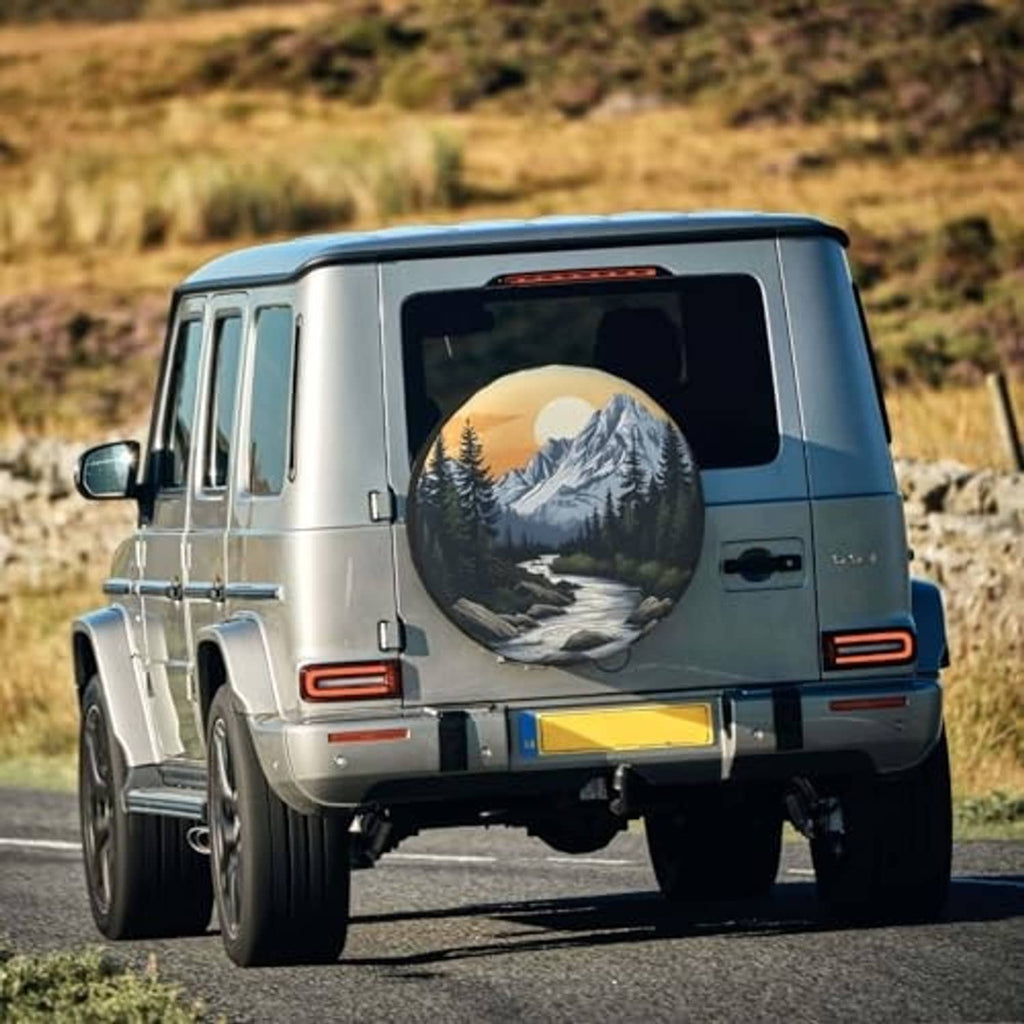Spare tire cover on SUV rear with mountain sunset landscape print