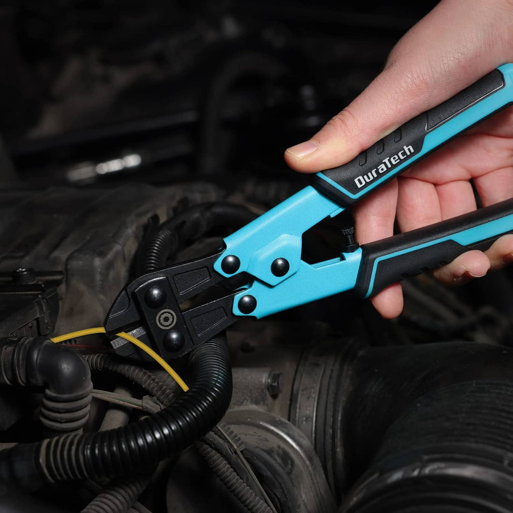 Mini bolt cutter held in an engine bay, with turquoise handle and black jaws