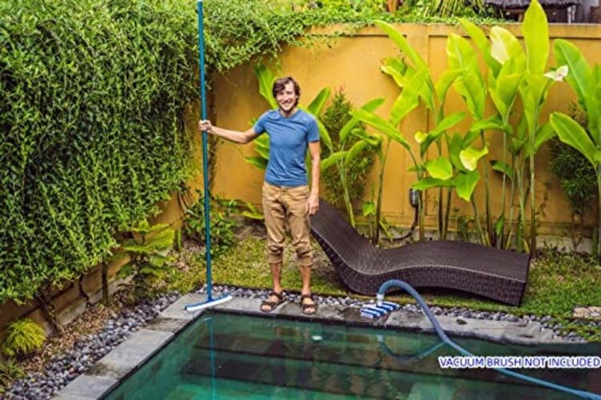 Telescopic pool pole standing above a small backyard pool, blue anodized aluminum shaft
