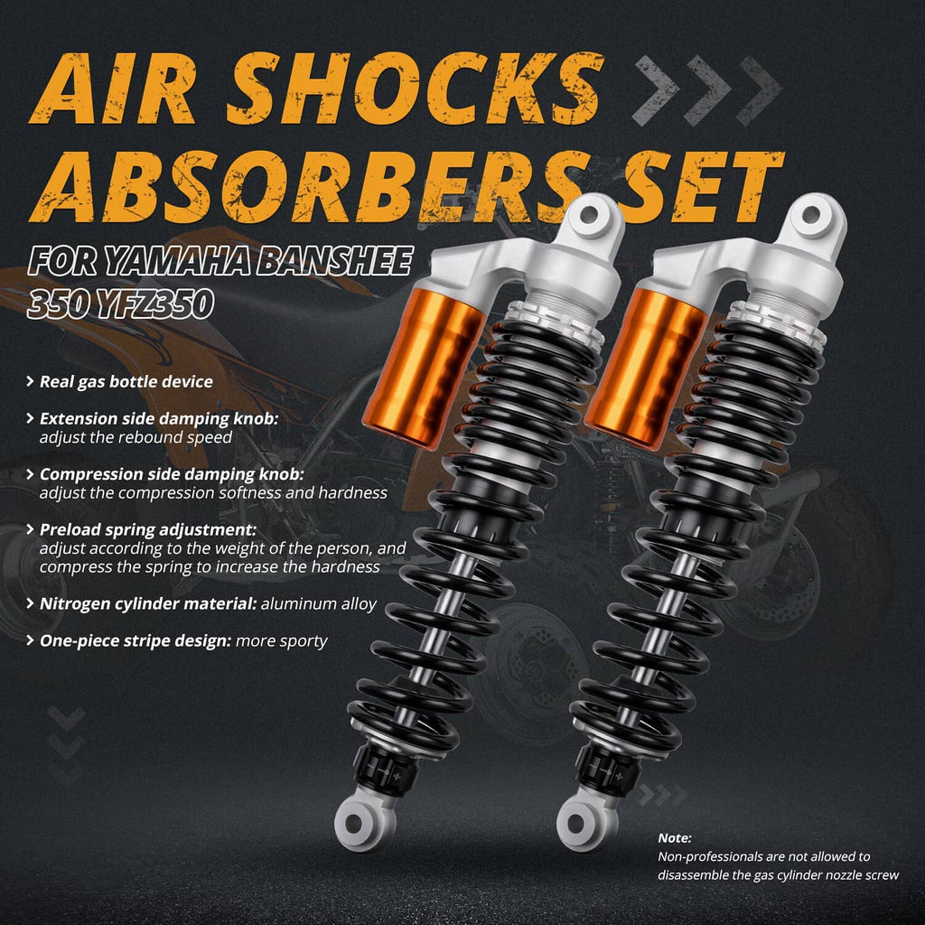 Front shock absorbers pair with orange reservoirs and black coil springs, silver upper mounts