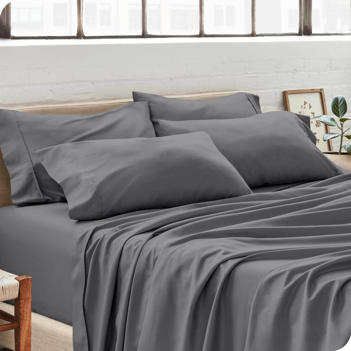 Grey standard pillowcases on bed, smooth microfiber finish with matching set.