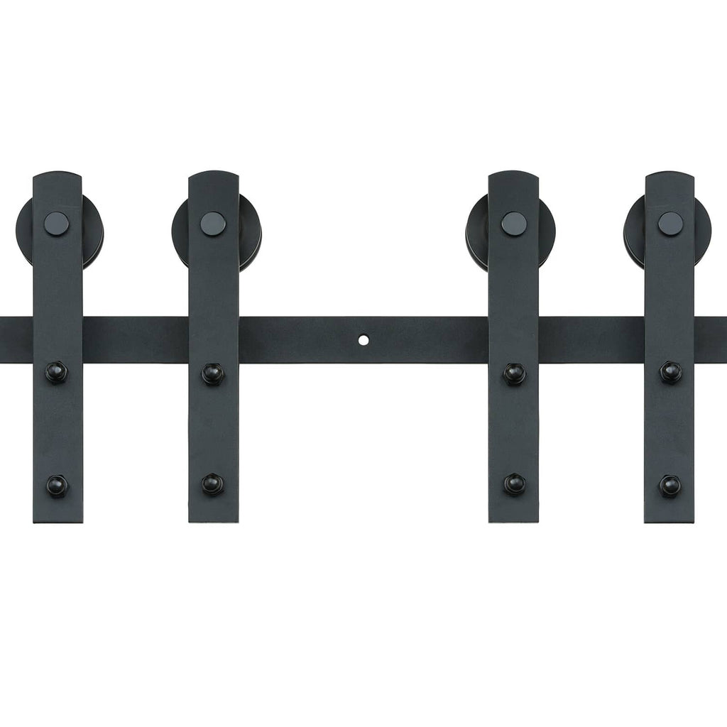 Black barn door track hangers with round roller wheels on a mounting rail