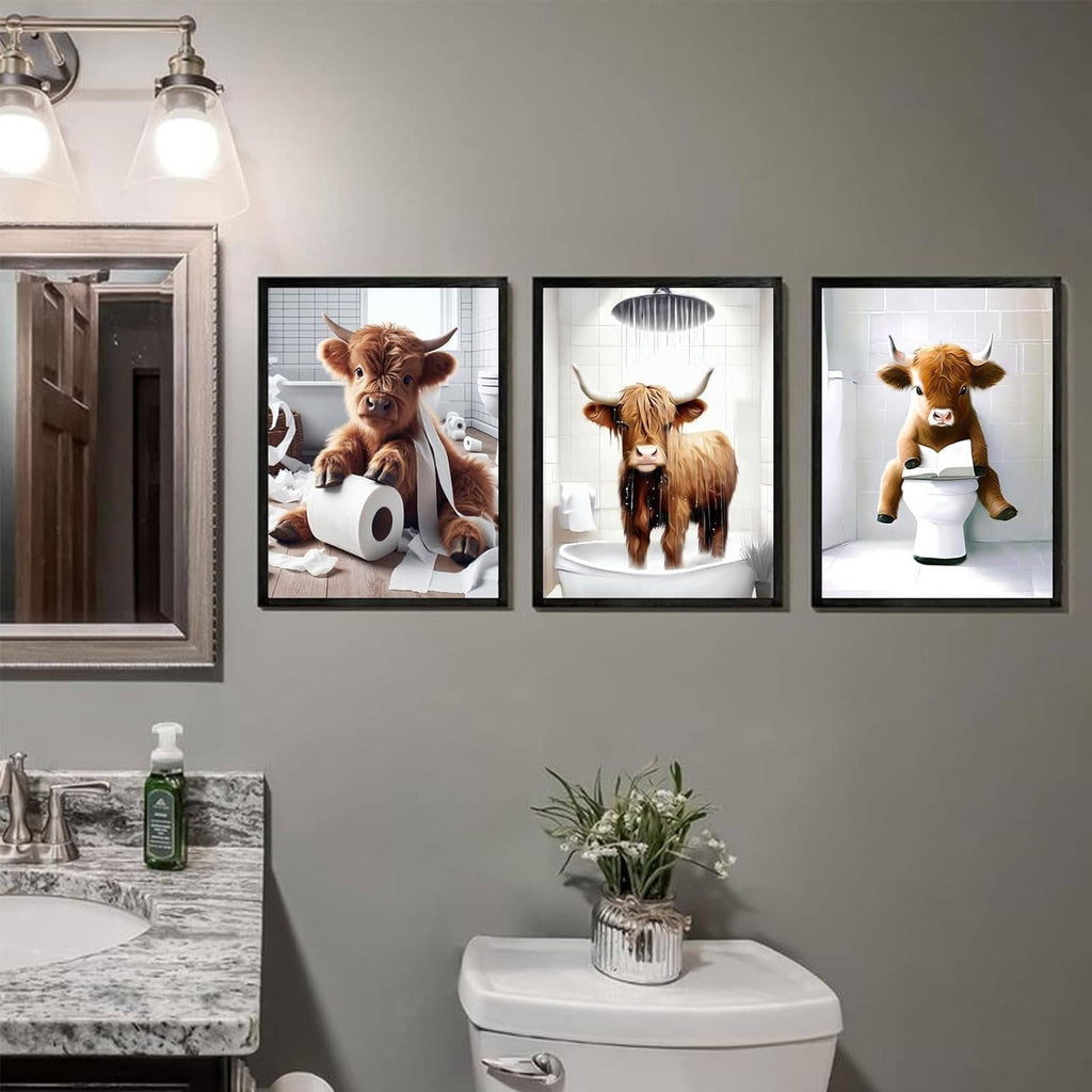 Three framed Highland cow bathroom wall prints arranged above a white sink