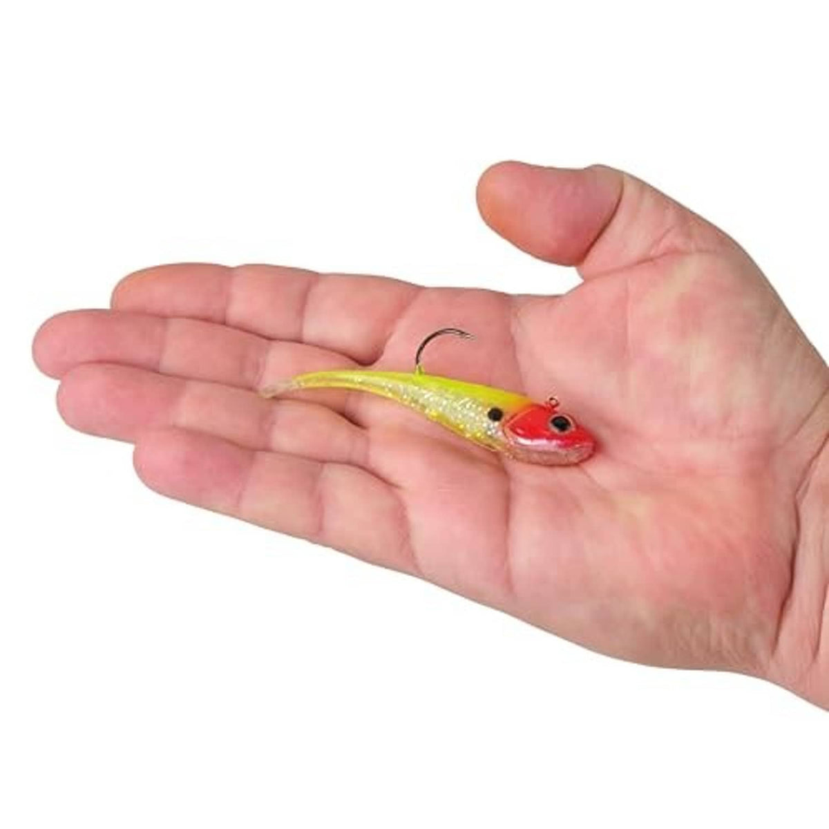 Soft plastic fishing lure in hand, red head and translucent chartreuse body with hook