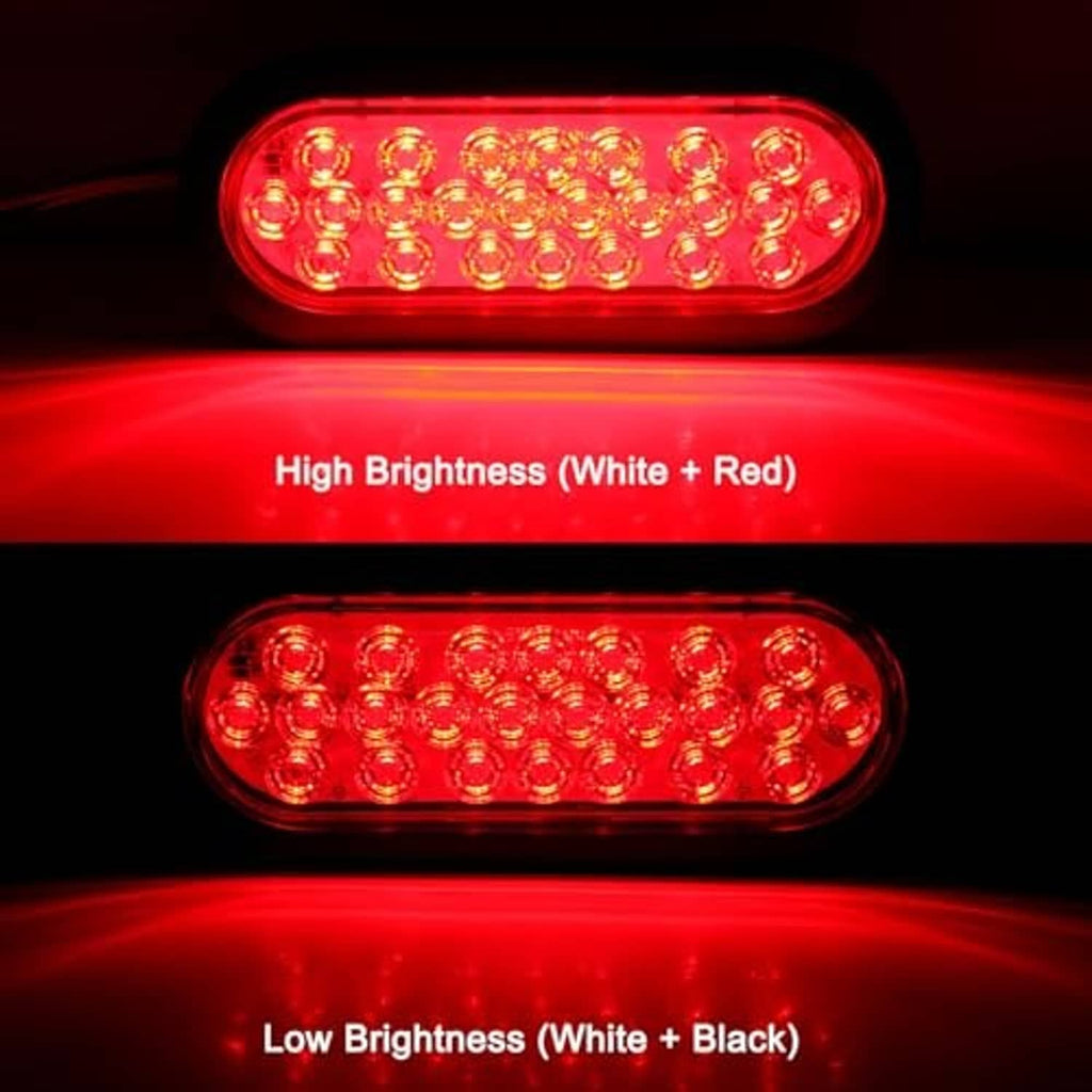 Red glowing oval LED trailer tail light with clear lens and black housing