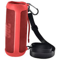 Red silicone speaker case with textured sides and wrist strap, includes carabiner clip
