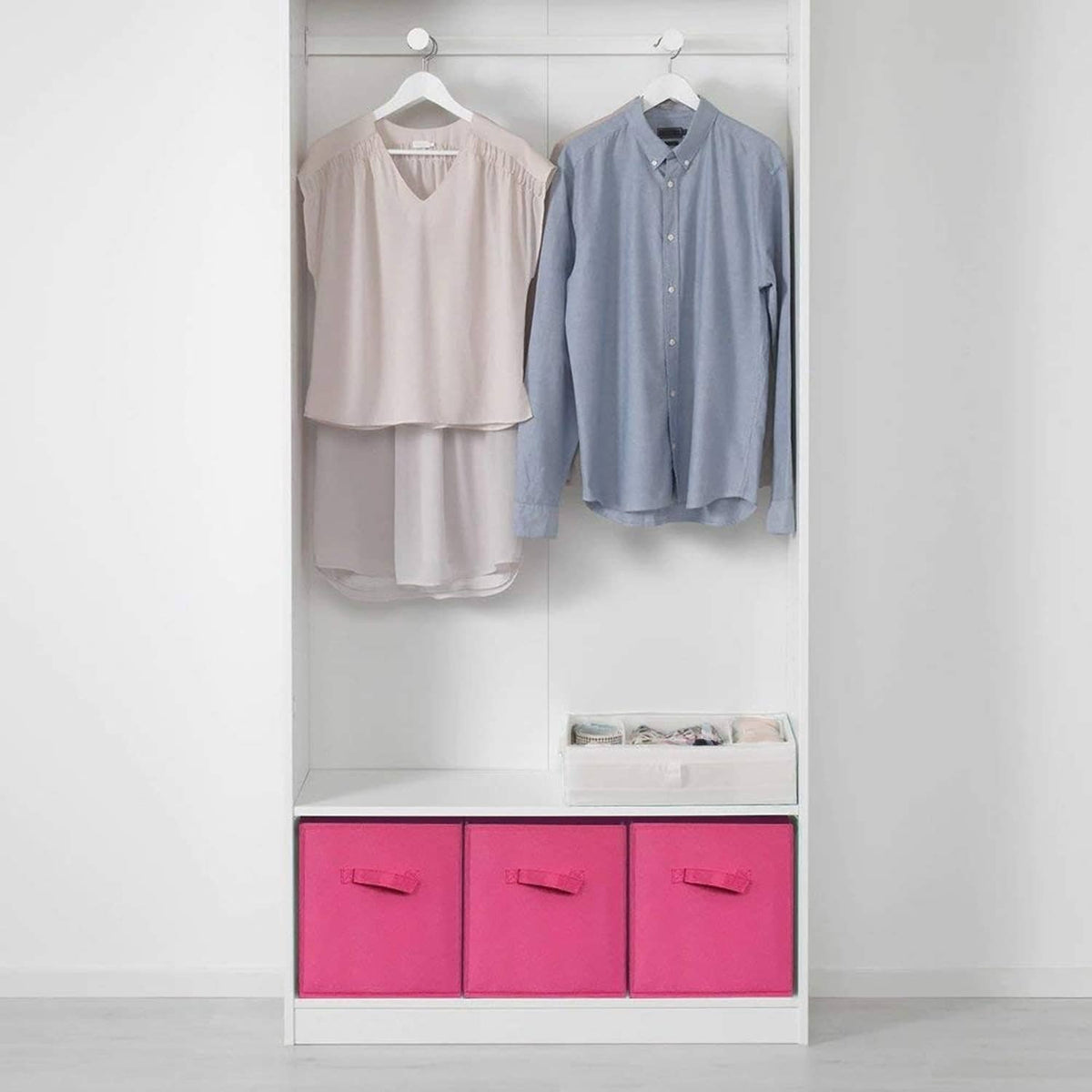 Fuchsia fabric storage cubes in closet shelving, three bins with front handles