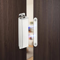 Stainless steel magnetic door catch engaged with strike plate on wooden door frame