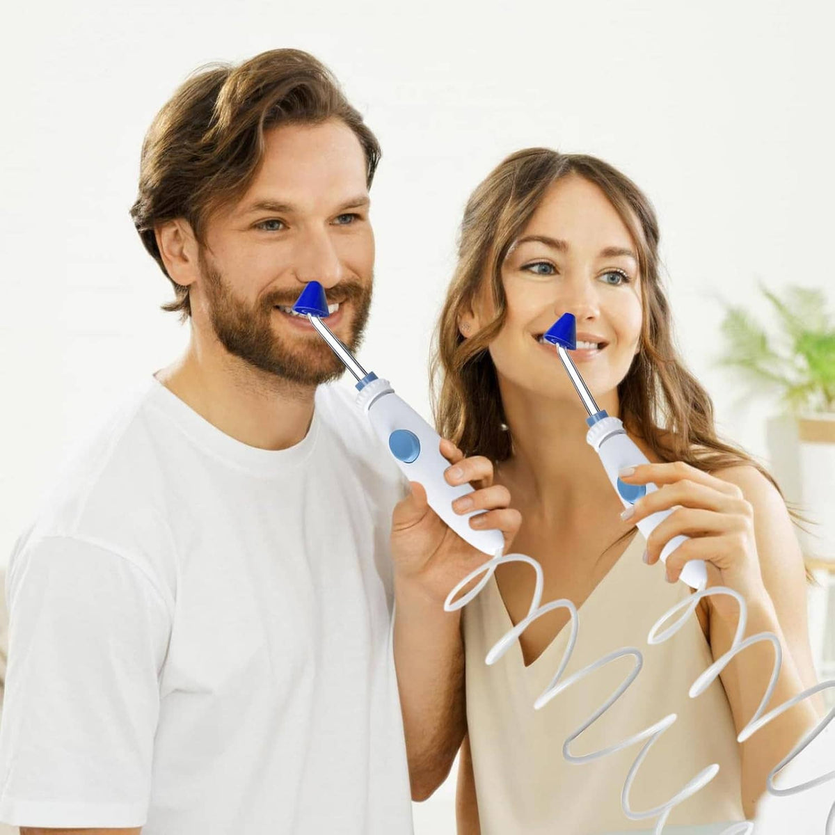 Blue nasal rinse tips with metal nozzles held in hands during use