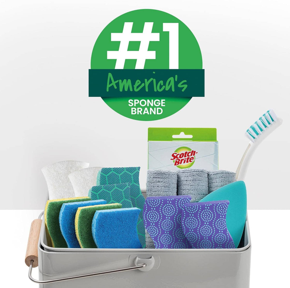Assorted scrub sponges in a metal caddy with retail box packaging.