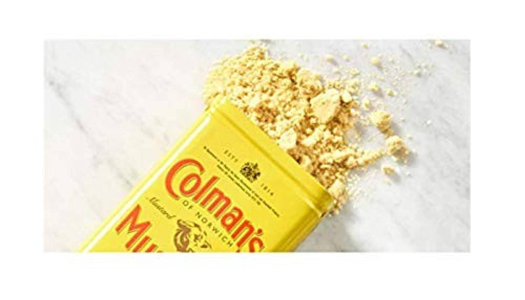 Colman's dry mustard powder pack beside yellow mustard crumbs
