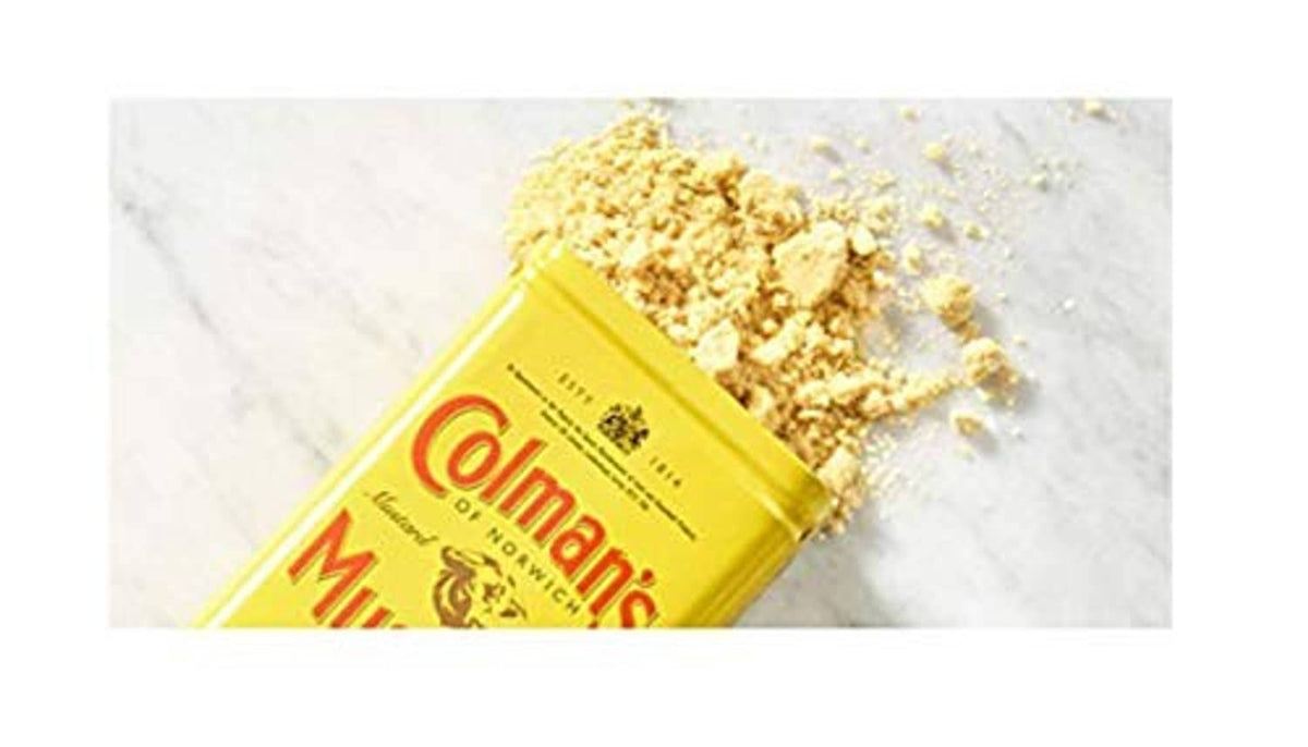 Colman's dry mustard powder pack beside yellow mustard crumbs