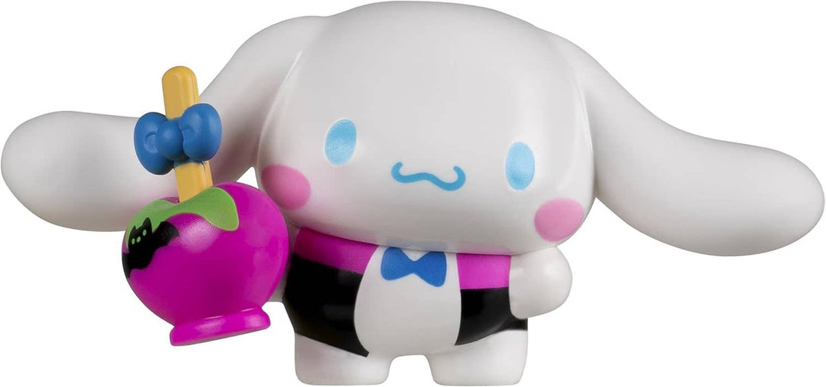 White and blue character figure holding a pink pumpkin accessory