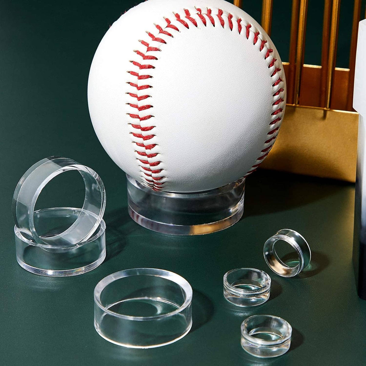 Baseball on clear acrylic sphere stand with several spare ring holders arranged around