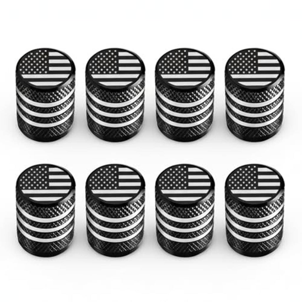 Set of 8 tire valve stem caps, black textured bodies with engraved U.S. flag top discs.