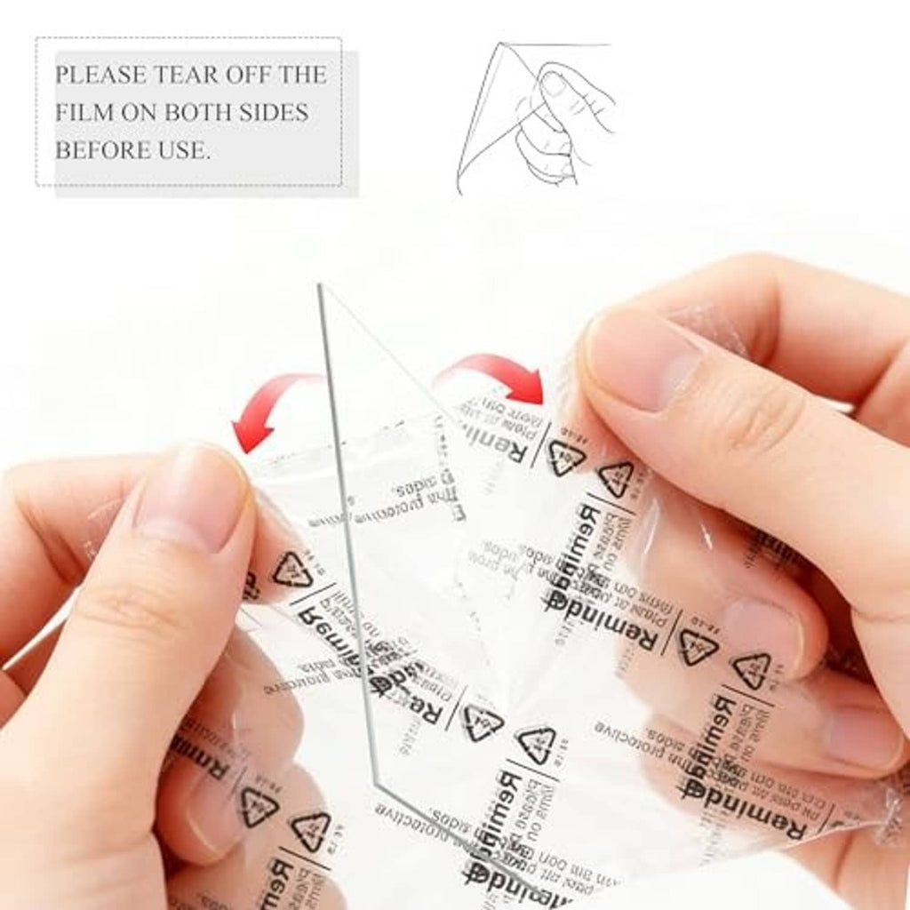 Hands removing protective film from a clear cover on a black picture frame