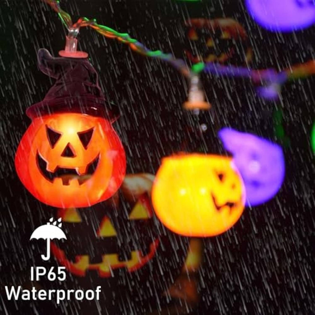 Solar pumpkin string lights with glowing jack-o'-lantern bulbs in the rain.