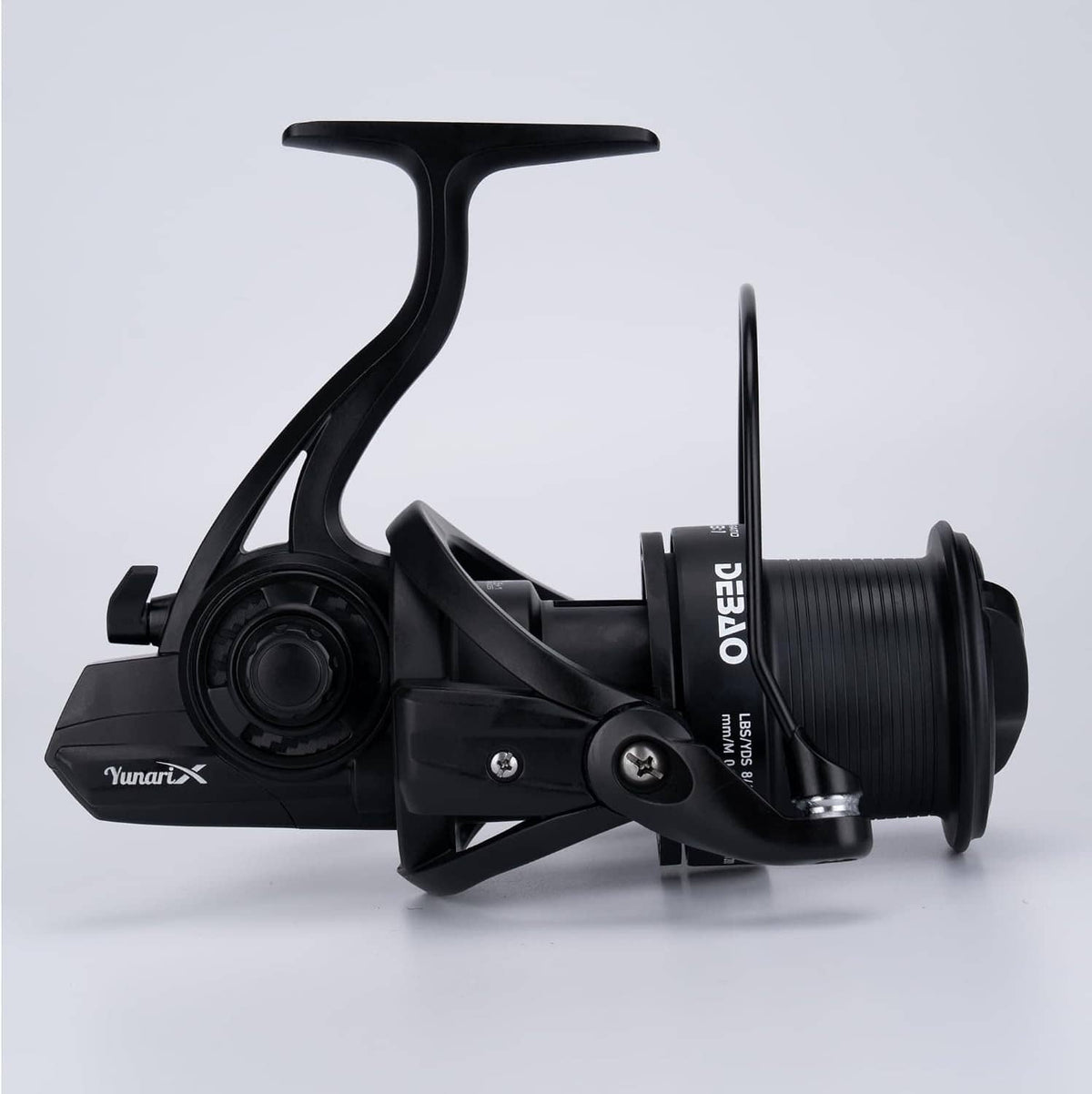 Black spinning fishing reel side view with long handle arm and ribbed spool