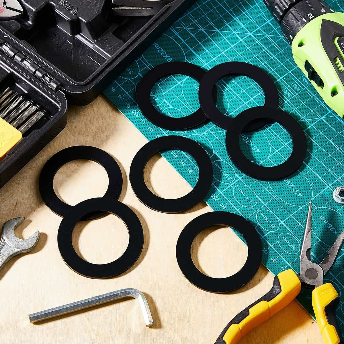 Black rubber gasket washers set with inner holes on workbench