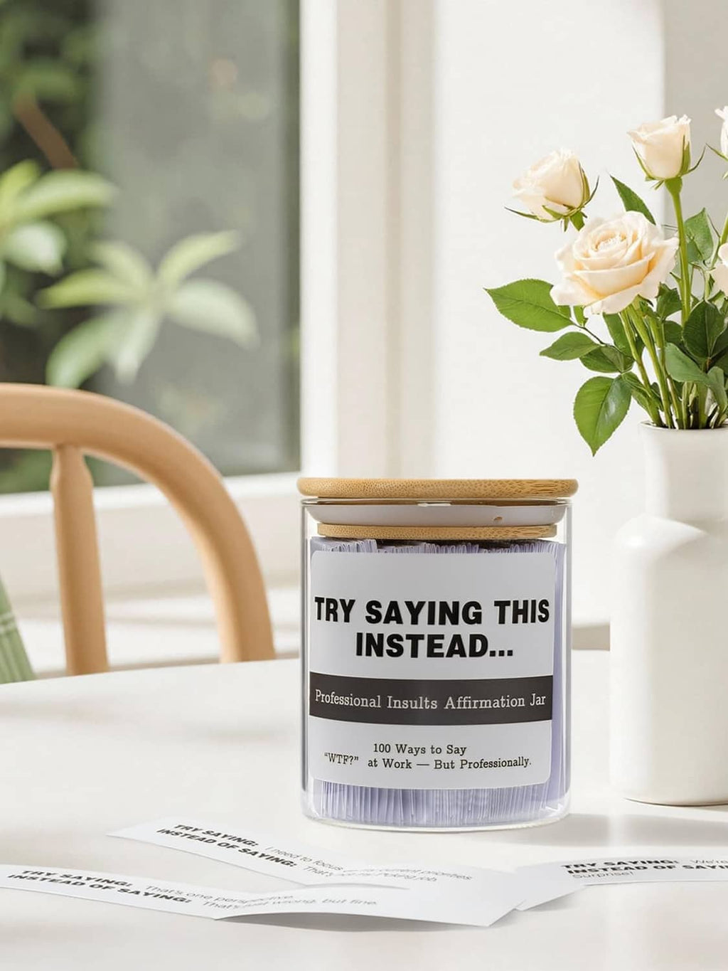 Glass affirmation jar on table with bamboo lid and printed work label