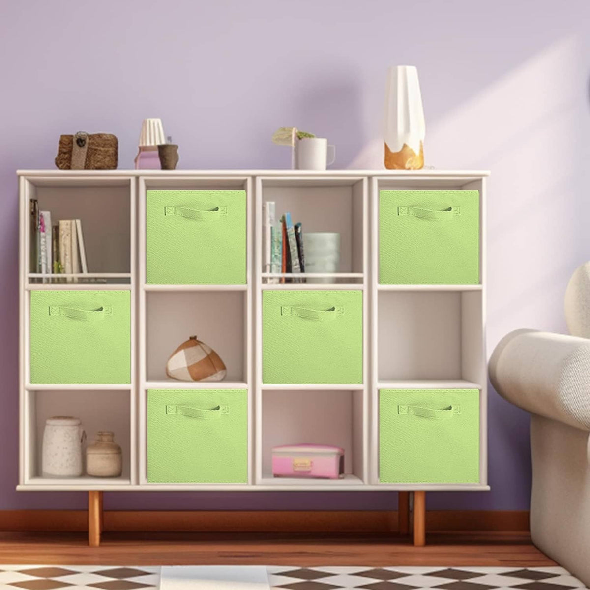 Green foldable storage cube with front pull handle inside a white bookshelf